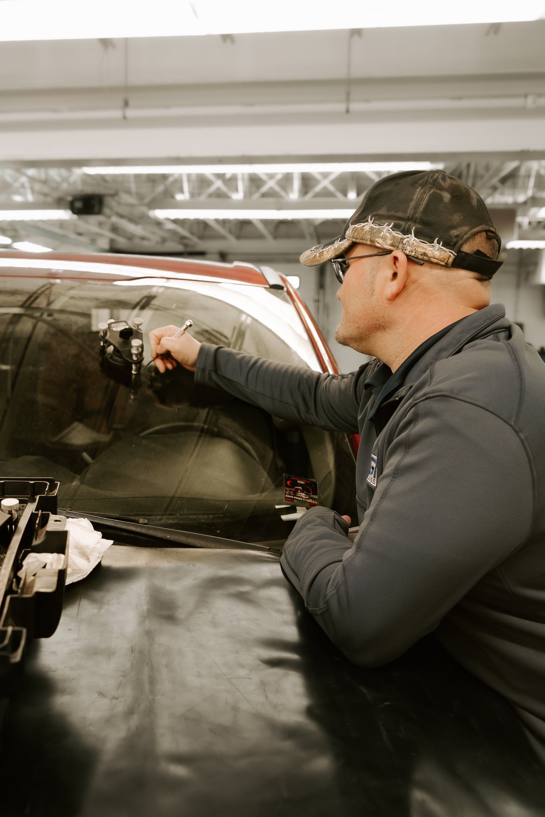 SGI technician repairing a rock chip in a windshield