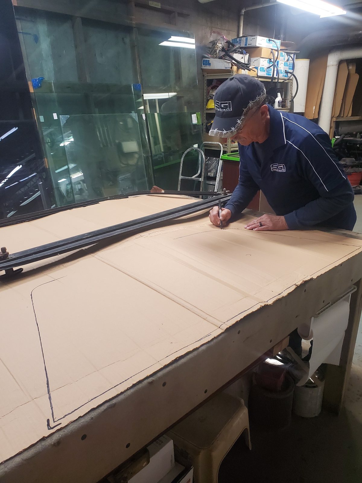SGI technician measuring flat glass at the bench
