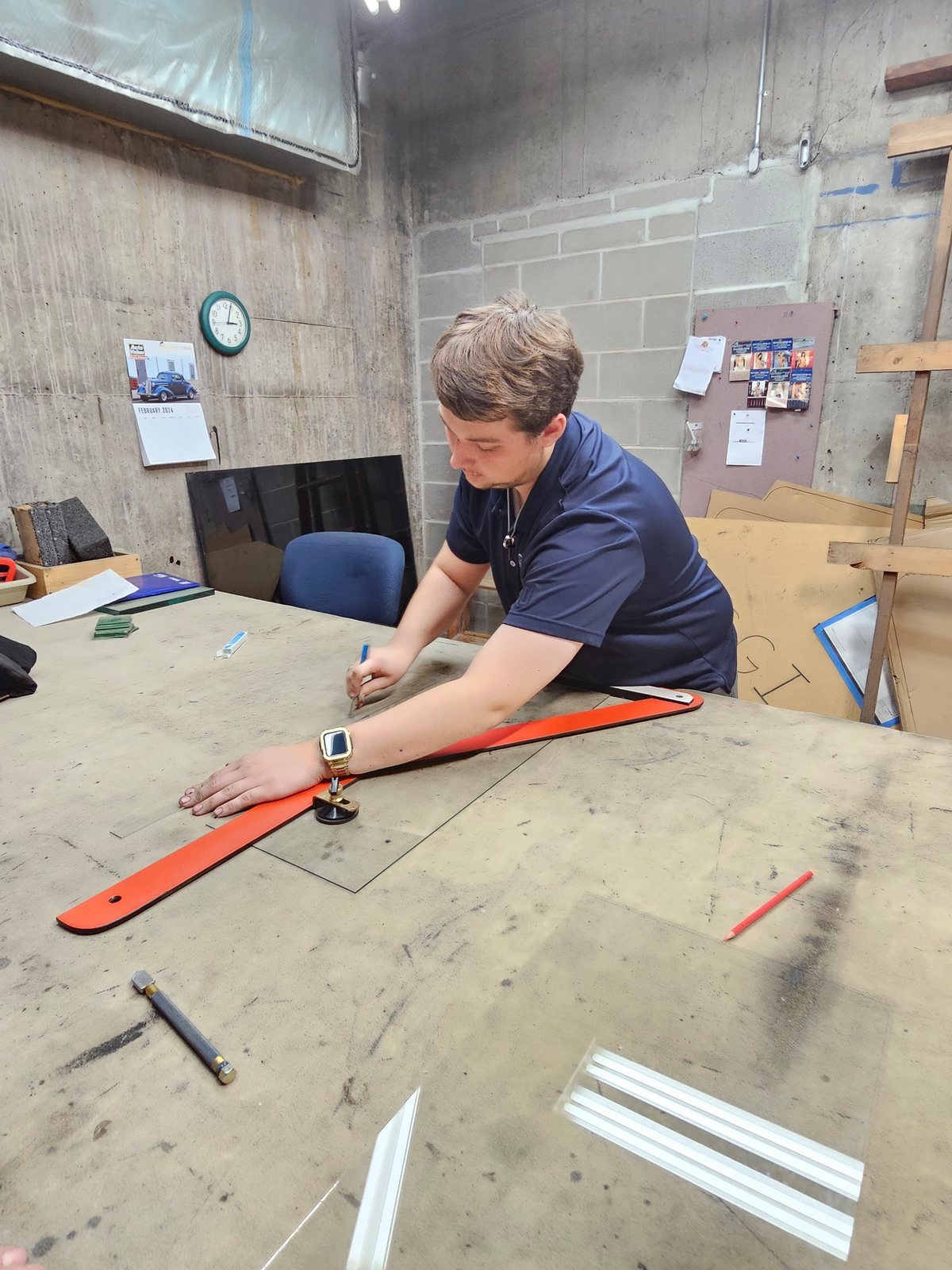 SGI technician marking and cutting flat glass at the bench