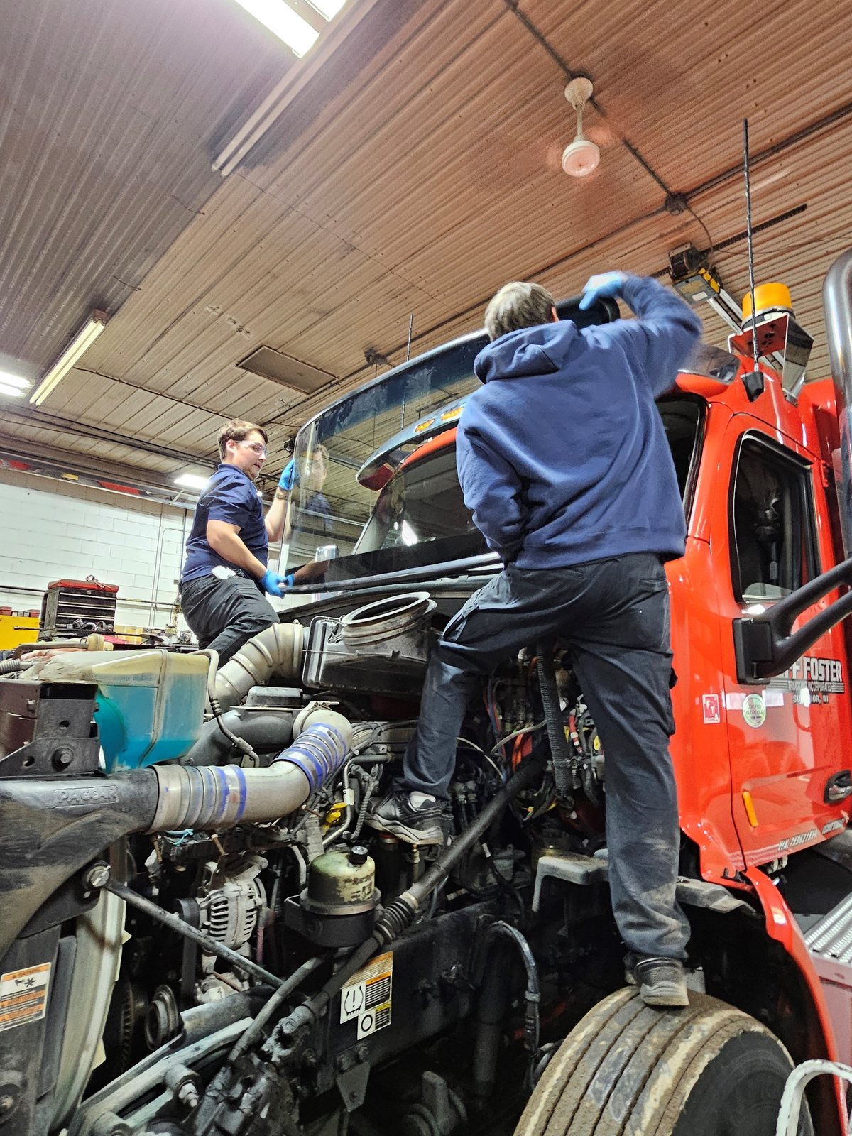 SGI technicians replacing glass on a semi tractor