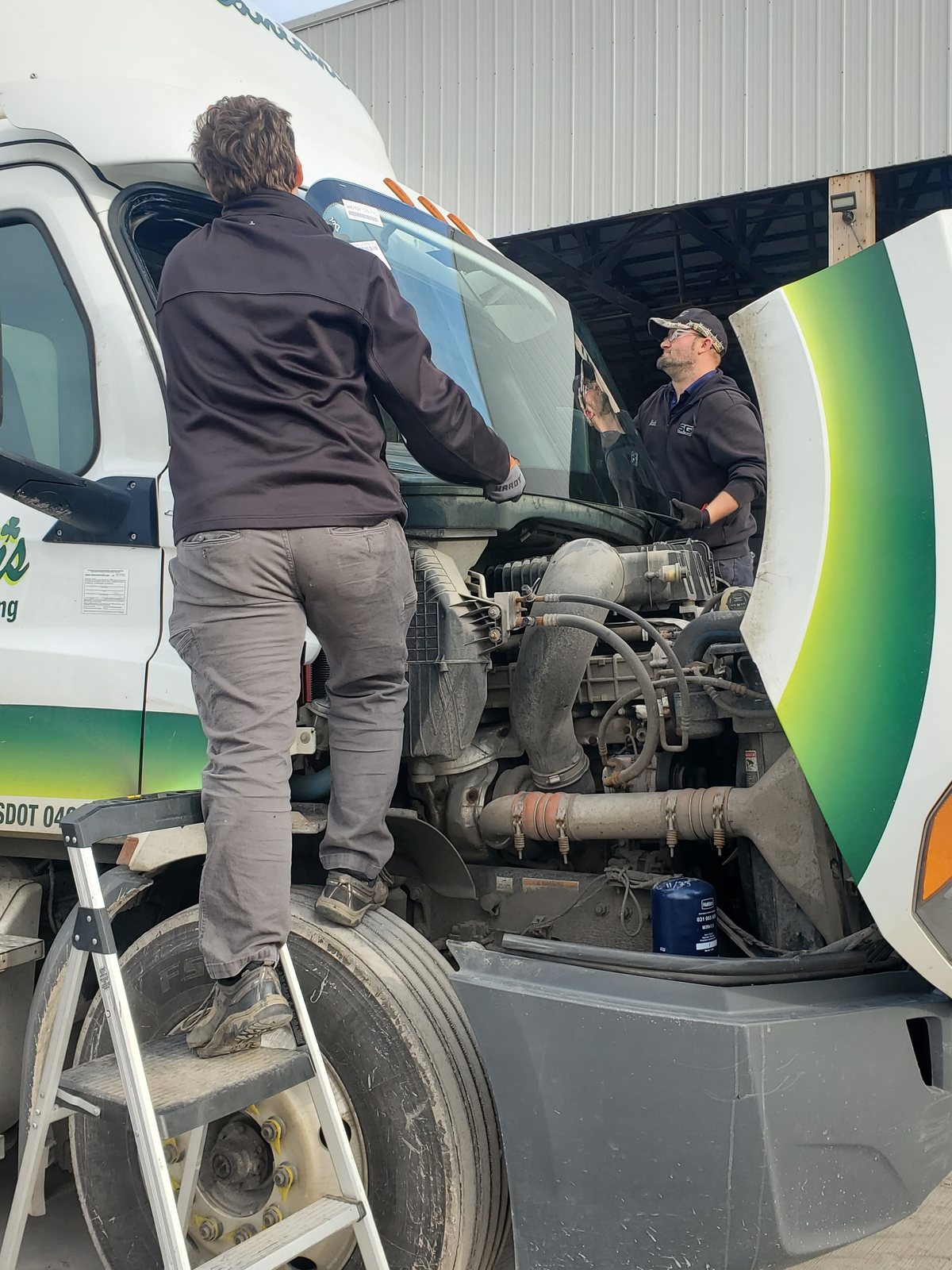 SGI technician working on a semi tractor windshield